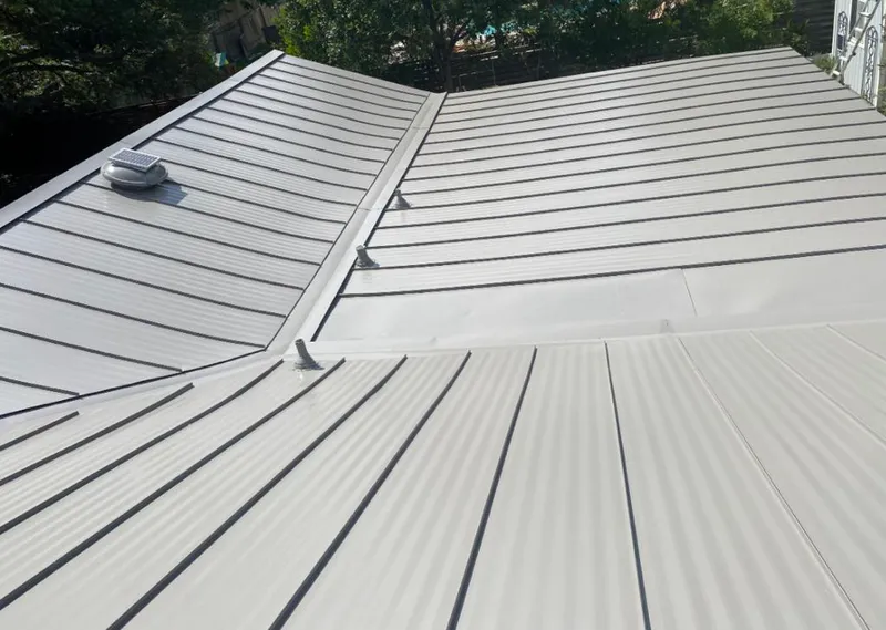 Solar attic fan installed on a metal roof for Roof Ventilation in Westland